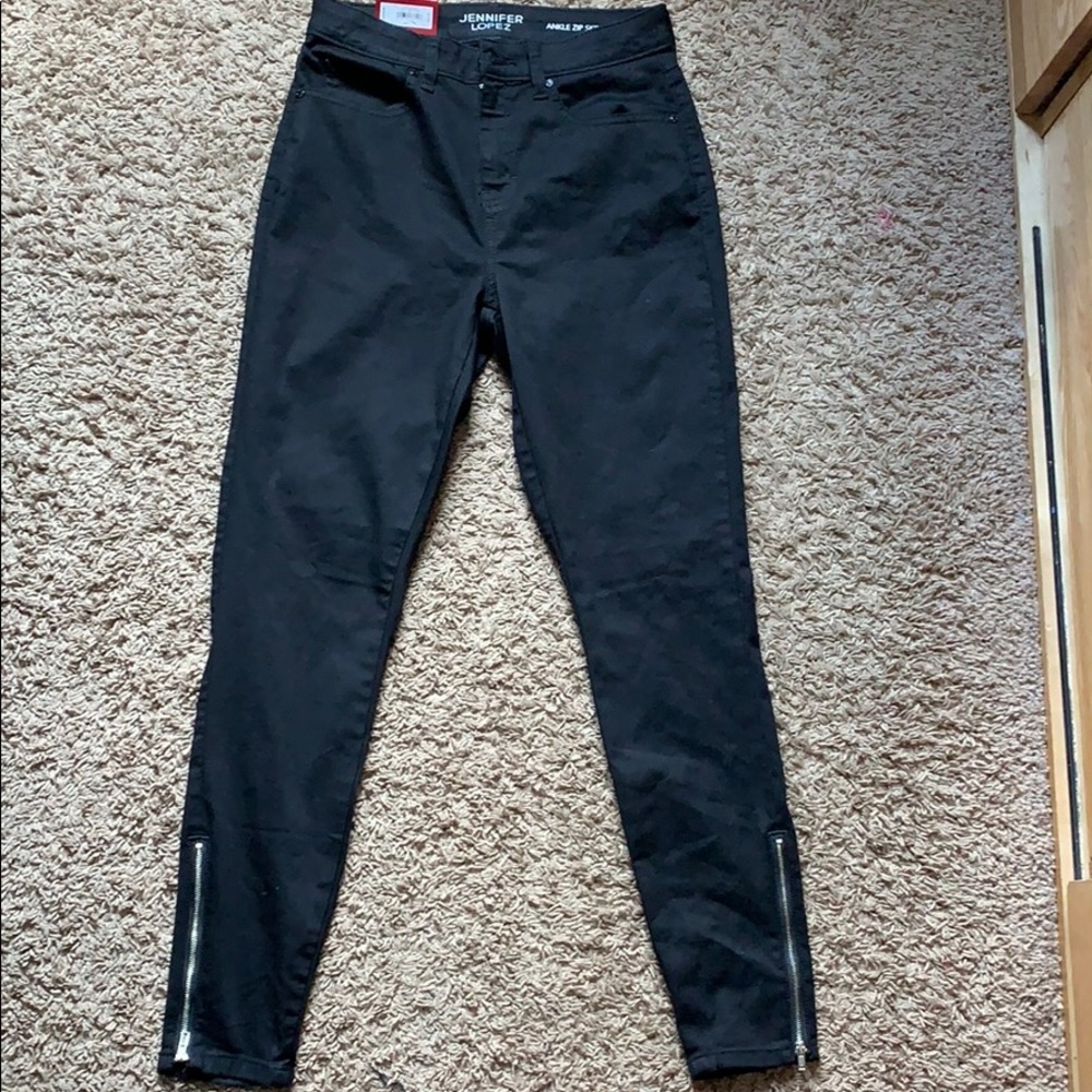 Black jeans with zippers on the ankles